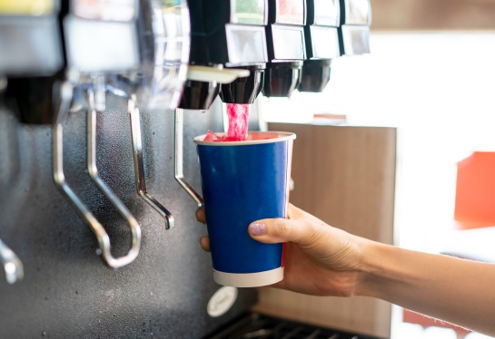 Foto mano sirviéndose refresco de una máquina de refil Foto mano sirviéndose refresco de una máquina de refil